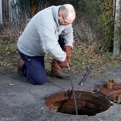 Certified technician providing septic system maintenance